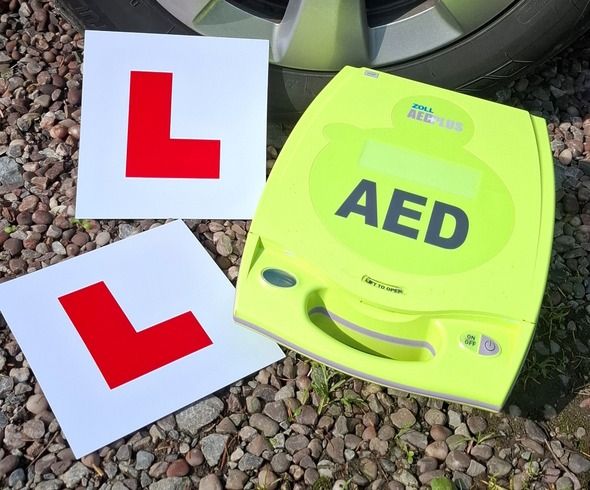AED next to L plates on the floor