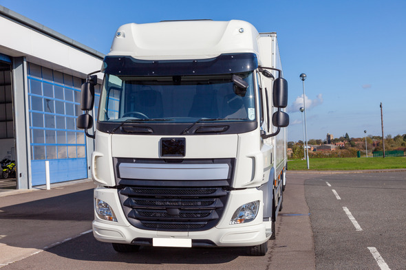 Front view of a white lorry in empty car park