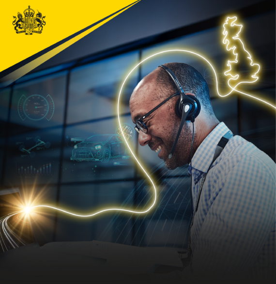 Male employee with headset working at computer 