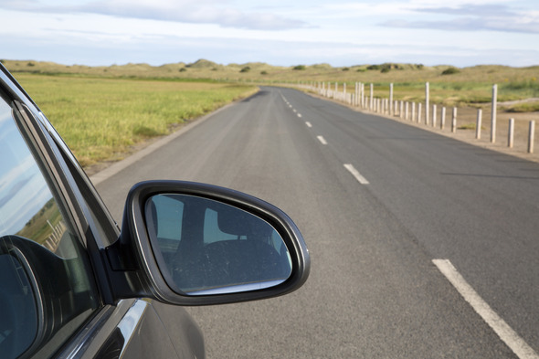 Close up of a car driving along a country road