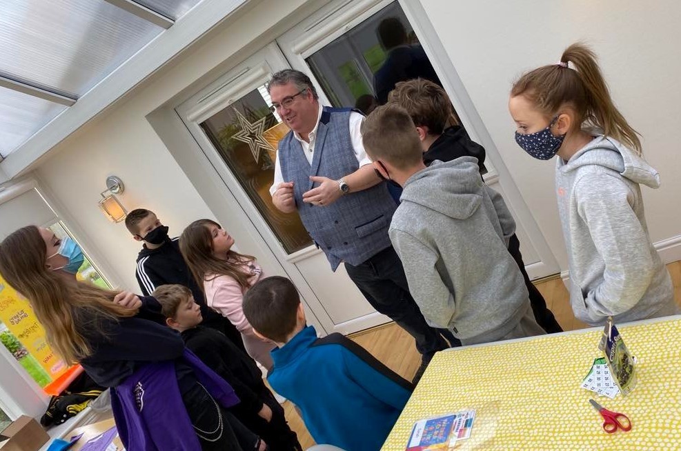 Scotty entertaining a group of children and young people