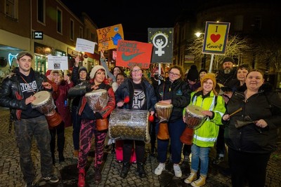 attendees at the Reclaim the Night event, holding banners, placards and posters