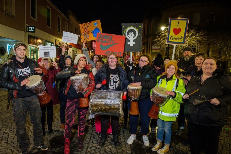 attendees at the Reclaim the Night event, holding banners, placards and posters