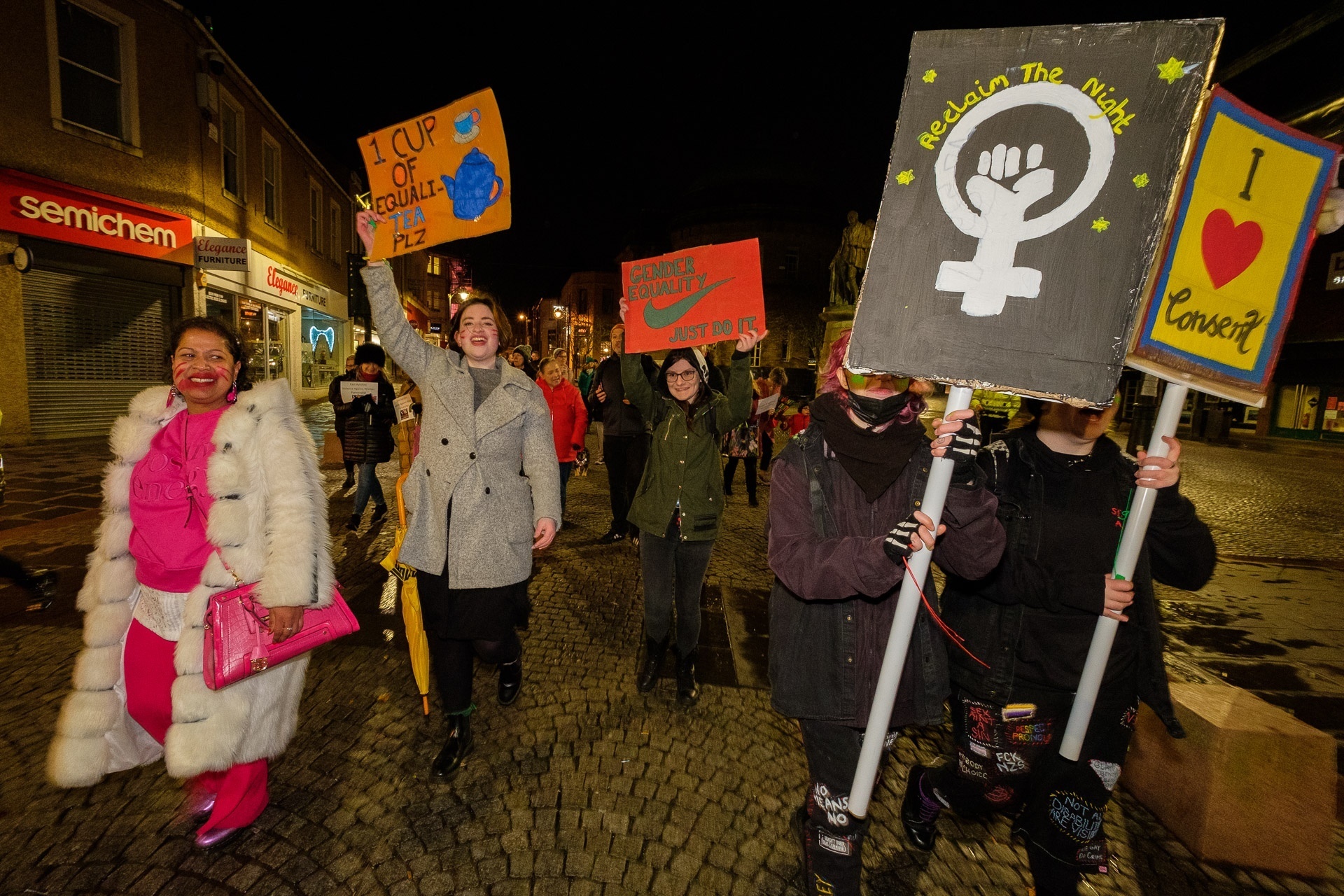 attendees at the Reclaim the Night event, holding banners, placards and posters