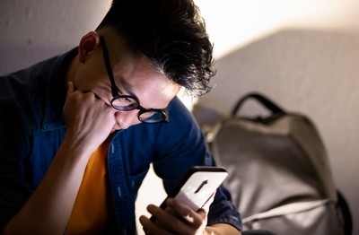Man looking worried while looking at his phone