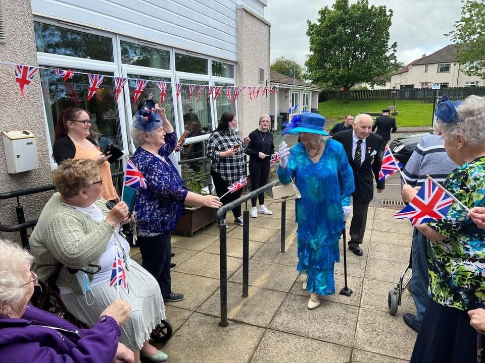 Residents outside a care home enjoying the entertainment