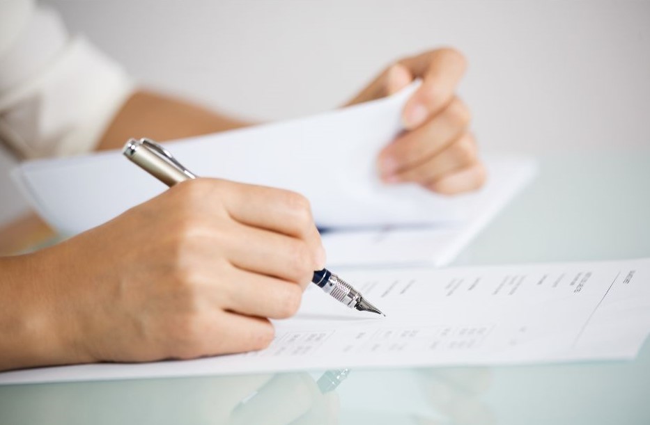 a person's hands writing