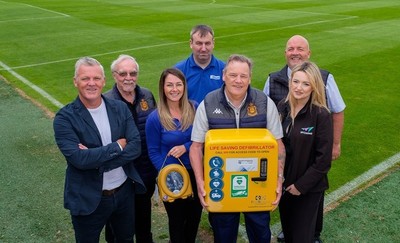 Staff from Auchinleck Talbot FC holding their new defibrillator