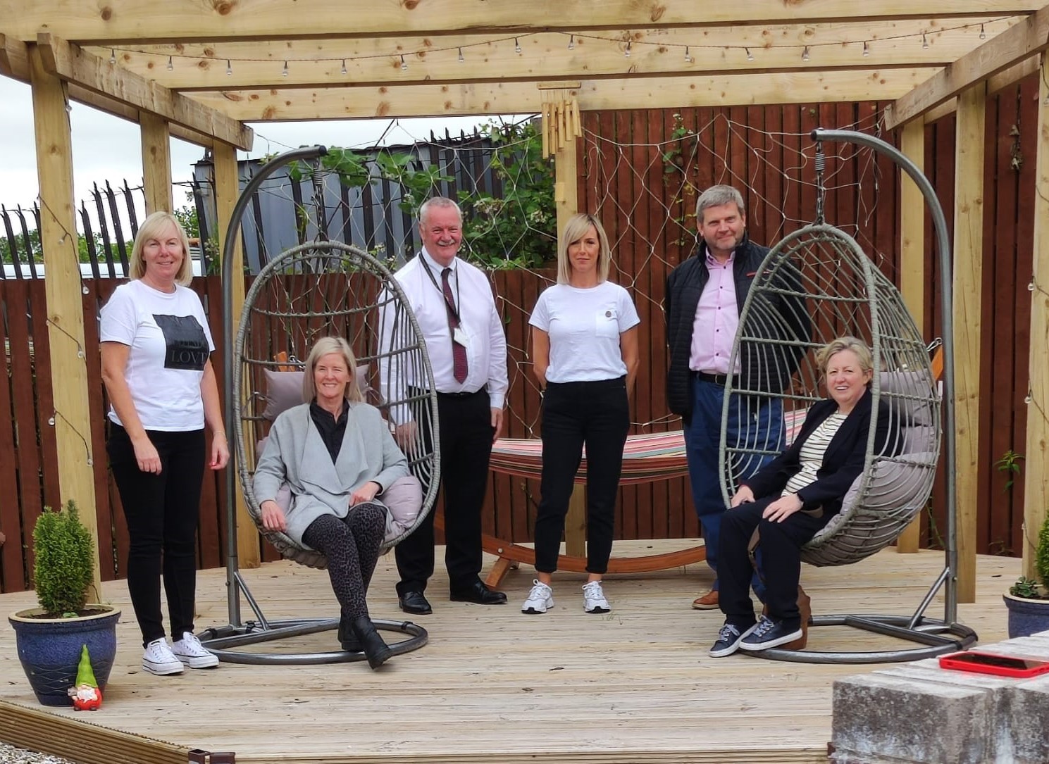 Craig McArthur, Eddie Fraser, Marion MacAulay and Clare Wilson visiting a newly refurbished children's home garden