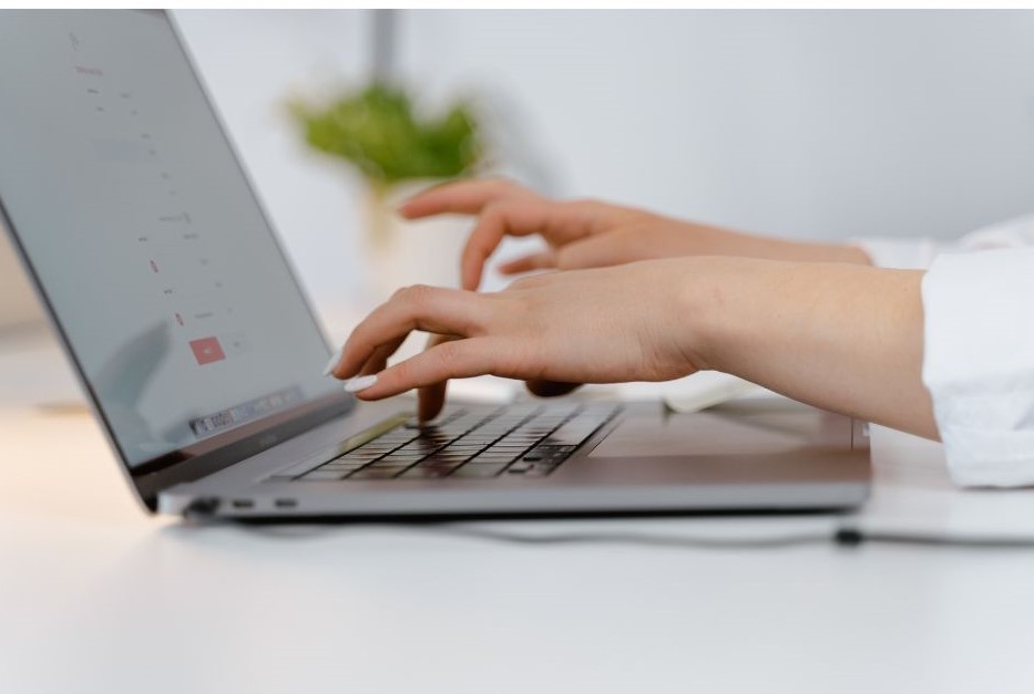 Woman typing on her laptop