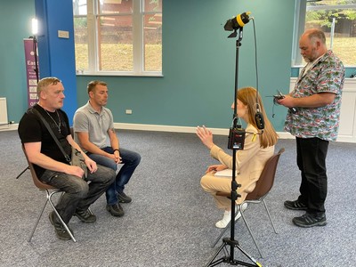 David Spencer and Geoff Brown speaking to STV journalist, Vanessa Taaffe in the new recovery hub building