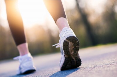 a person walking while wearing trainers