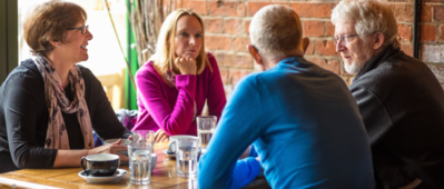 Adults chatting over coffee