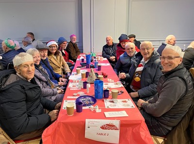 Guests seated at a table at the CHATmas party
