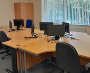 flexible workspaces with desks, chairs and pc monitors