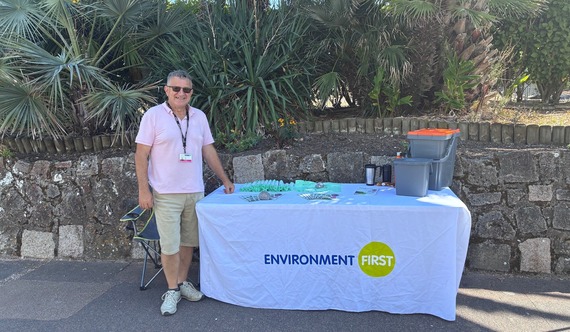 neil peters recycling coordinator on eastbourne seafront standing by an exhibition stand