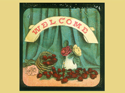 A magic lantern slide of a welcome sign over a vase and basket of red roses with a green curtain behind