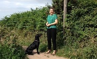 Young woman with her black dog
