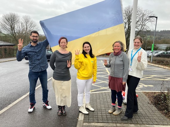 The Homes for Ukraine team outside Blackdown House with the Ukranian flag