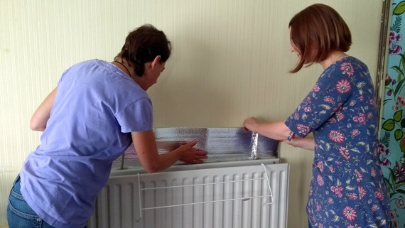 Reflective radiator panel being fitted