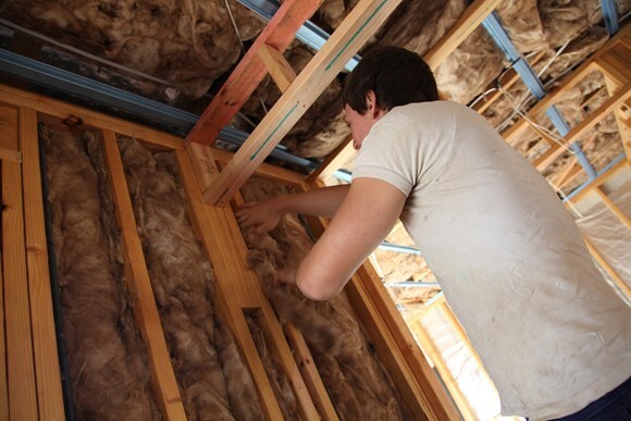 person fitting wall insulation
