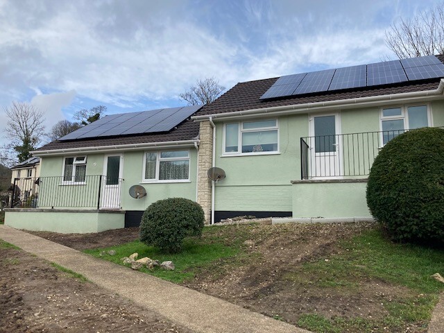 A photo of two bungalows in East Devon with solar panels on the roof