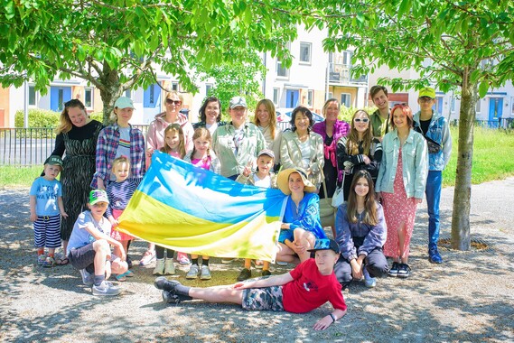 Photo of a group of people with a Ukranian flag. Credit: Ihor Andriienko