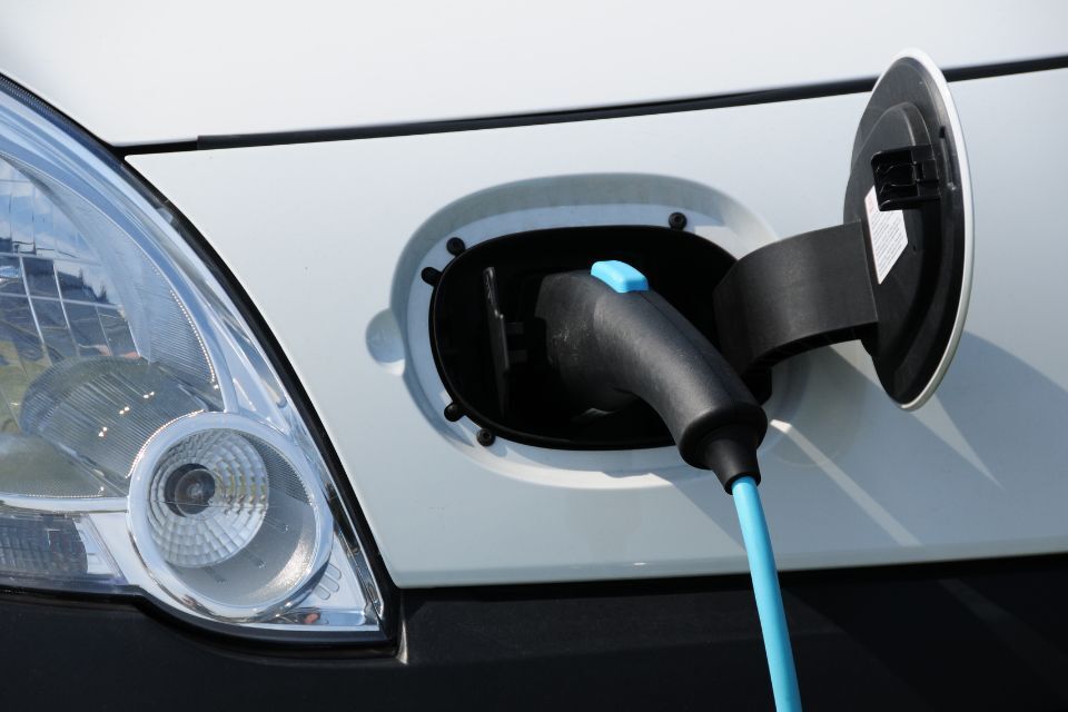 Photo of an electric car plugged into a charging port