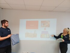 two people presenting in front of a whiteboard 