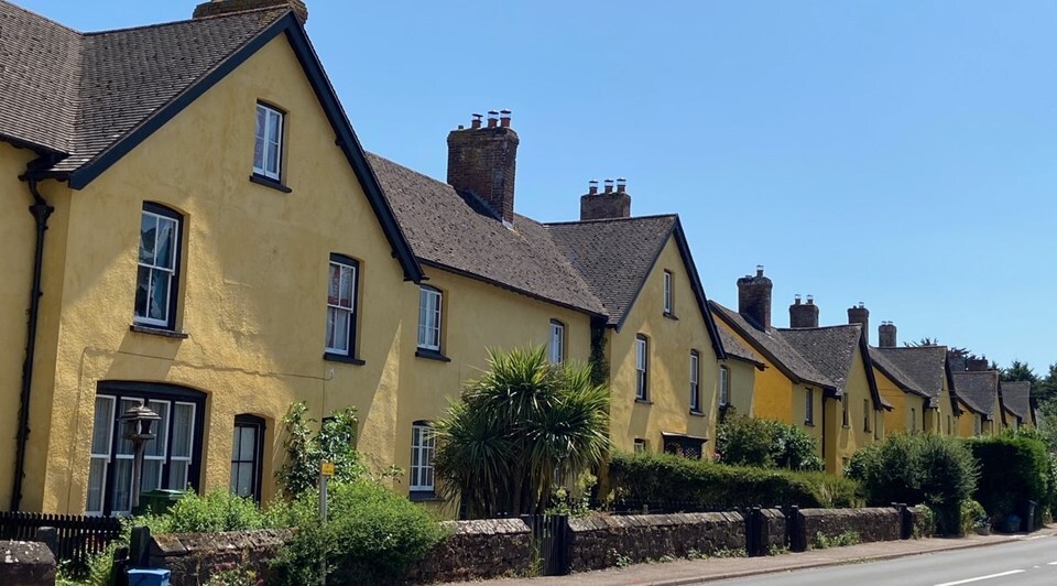 Street scene of yellow houses in Broadclyst 