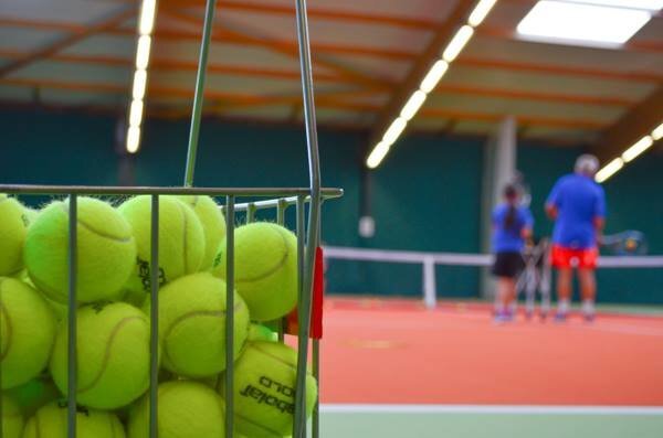 Photo of tennis balls and a court at Exmouth Tennis and Fitness Centre