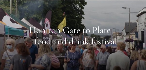 Honiton Gate to Plate food and drink festival. Photo of people walking through street with stalls.