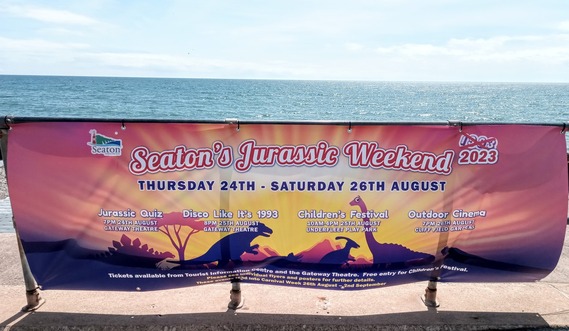Seaton Jurassic Weekend banner attached to the railings along Seaton seafront