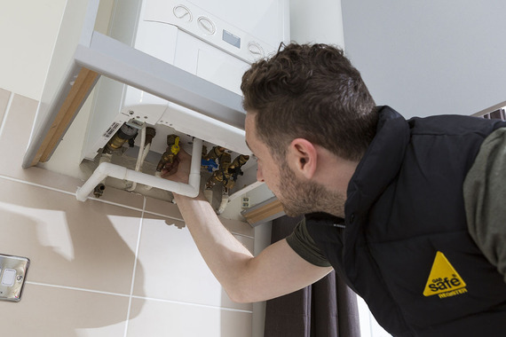 Photo of an engineer checking a boiler