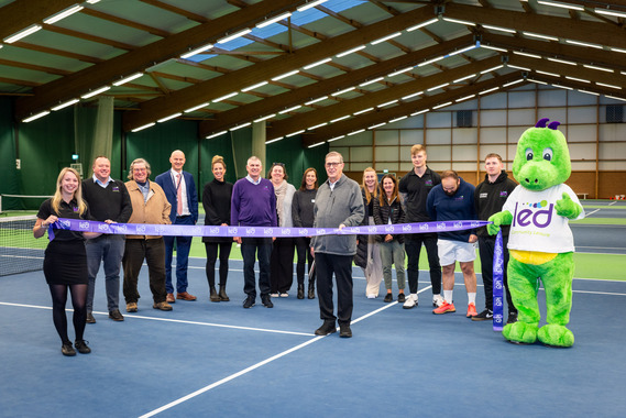 Councillor Nick Hookway opening LED's new Proflex tennis courts in Exmouth, with the LED team and mascot