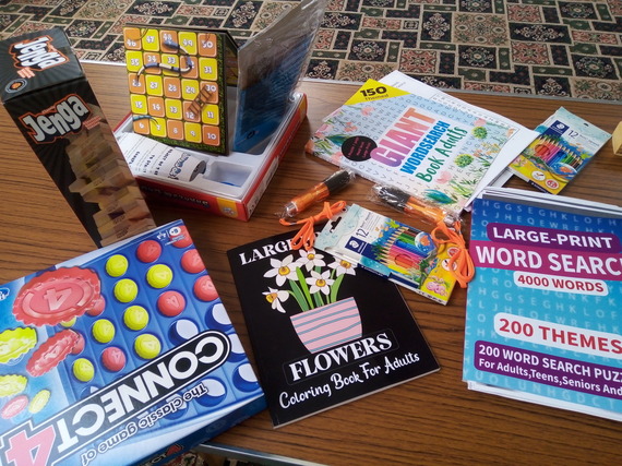 A variety of board games, art and craft activities and puzzles on a coffee table 