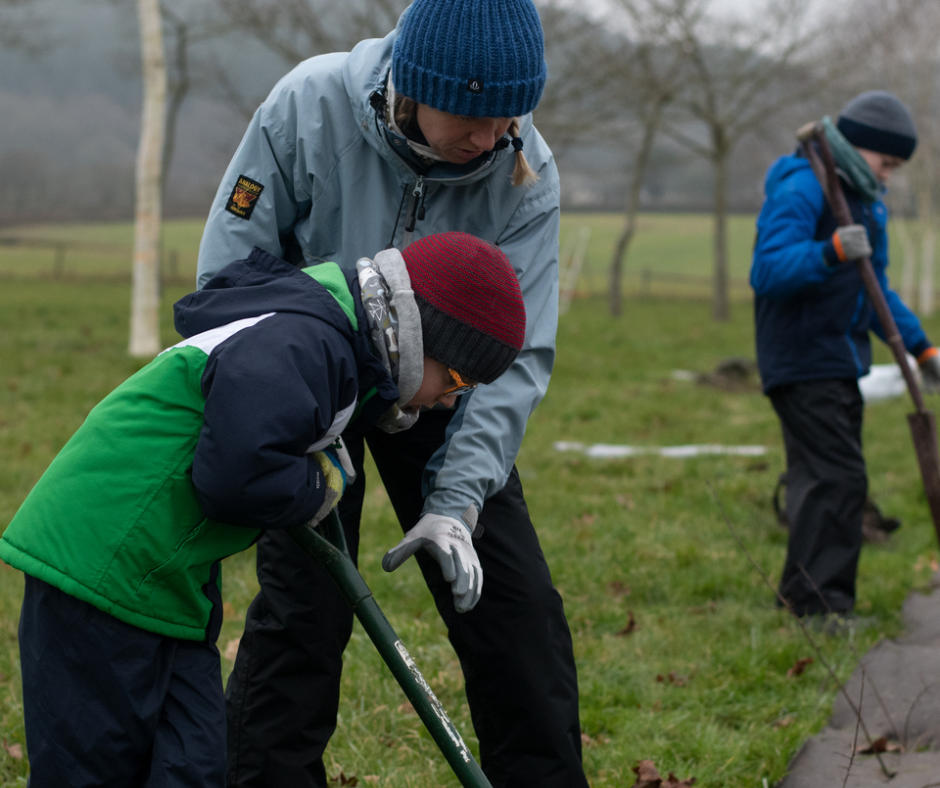 A women and child planting new trees