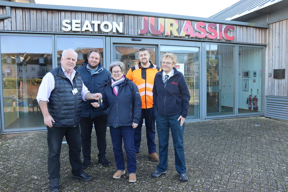Cllr Paul Arnott handing over the keys of Seaton Jurassic 