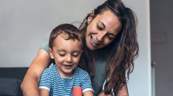 A mother and child playing with building bricks