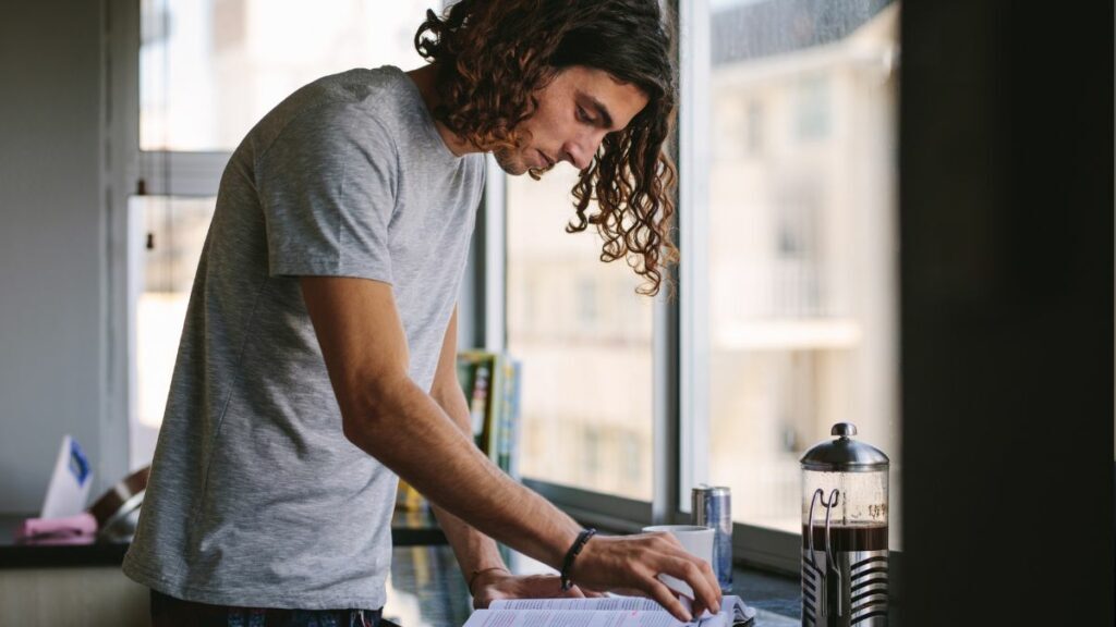 Photo of a young adult flicking through a textbook