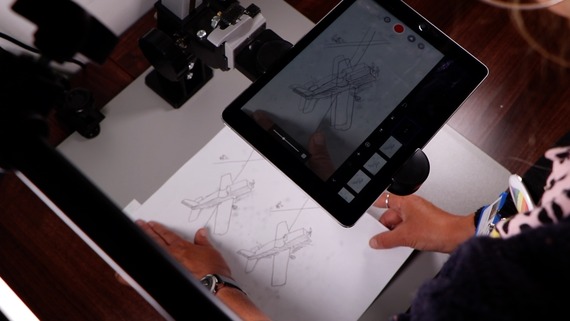 Drawings of a plane with an iPad recording it above