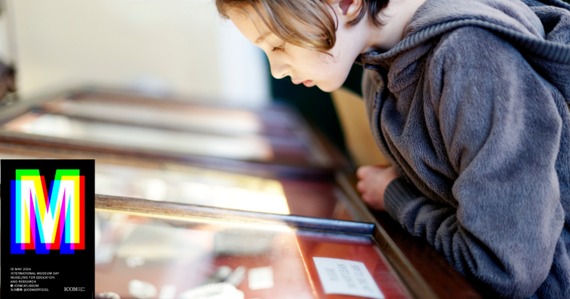 Photo of a child looking at a museum display. International Museum Day logo