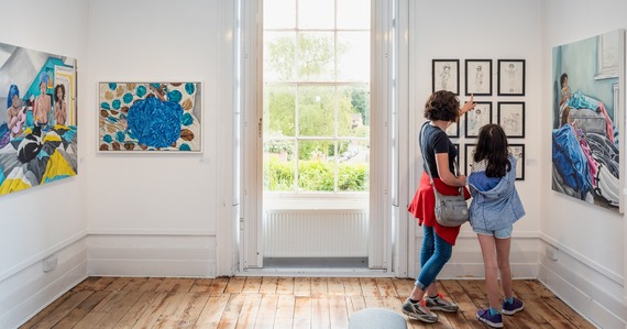 Photo of two people viewing the Thelma Hulbert Gallery's THG Open winners exhibition