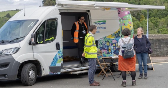 Photo of a South West Water van and staff talking with a member of the public