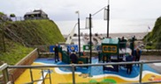 Beer play area. Ship play equipment. Beach and sea in the background