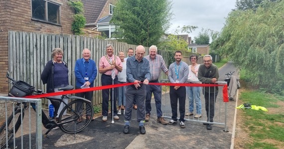 Representatives from East Devon District Council and Exmouth Town Council cut the red ribbon at the opening of the Bapton Valley shared-use path