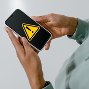 Phone with warning sign on the screen