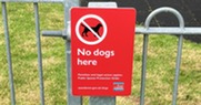 Signpost: No dogs here penalties and legal action applies public spaces protection order