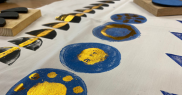 Foil print design on fabric - blue circles and black crescents with gold patterns