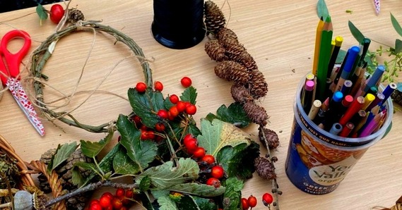 Winter berries, leaves, wreath, pine cones, and craft equipment